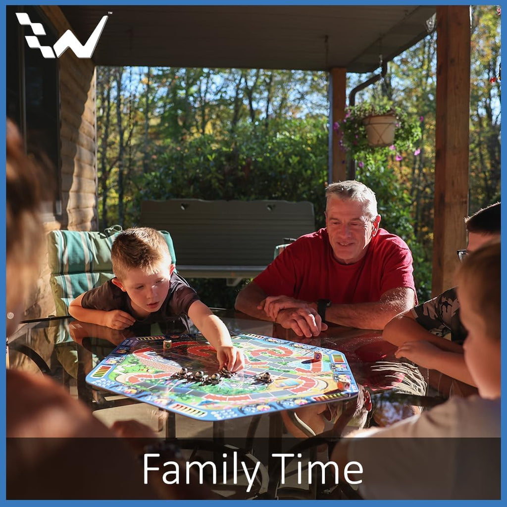 Family playing a board game outdoors on a sunny day