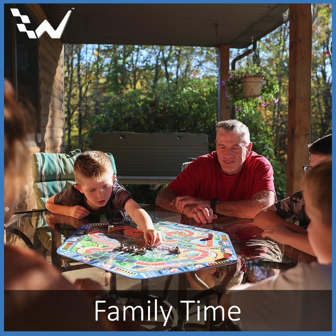 Family playing a board game outdoors on a sunny day