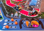 Close-up of a racing board game with car models and control panel.